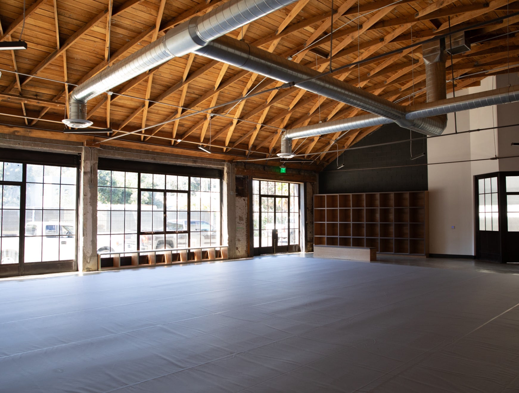 Wide view of the mat training space at Frogtown Jiu–Jitsu with storage cubbies in the background
